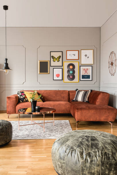 Eclectic living room interior with comfortable velvet corner sofa with pillows