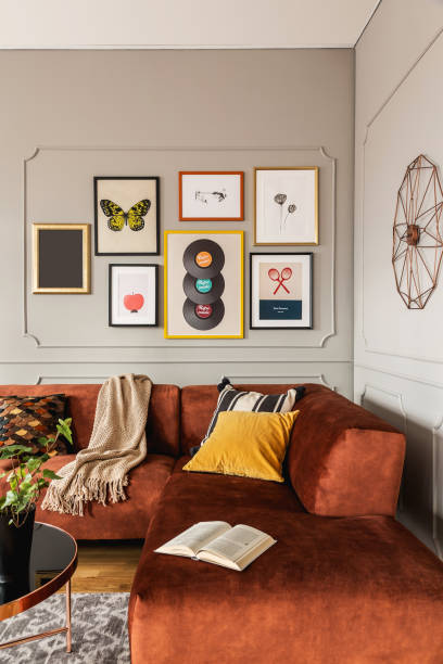 istock Elegant coffee table in front trendy sofa in modern living room interior with grey wall 1206897838