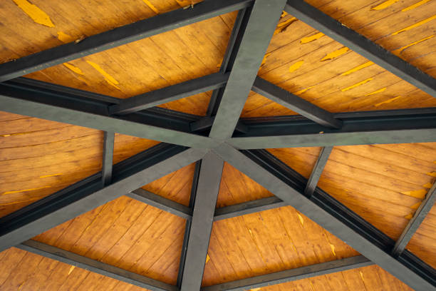 istock Metallic structure of beams support a wooden roof 1206897926