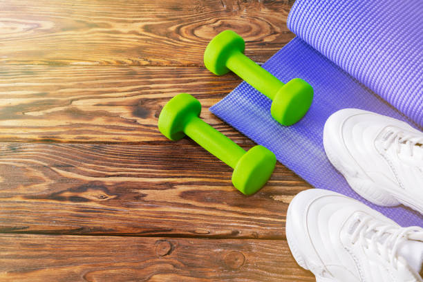 istock dumbbell sneakers on a bright background. Healthy lifestyle 1206898030