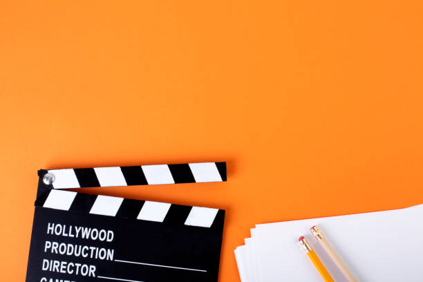 istock Movie clapper board on orange background with copy space. 1206898121