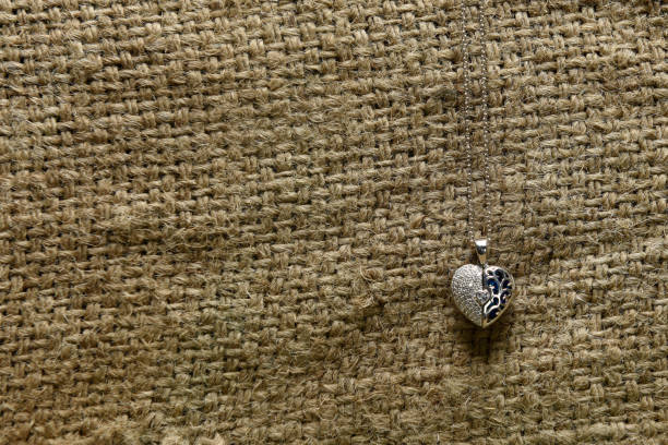 istock Silver necklace and pendant in the shape of heart 1206898310