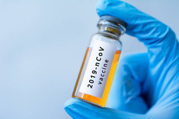 istock Coronavirus vaccine jar in medic's hand, pneumonia 1206899398