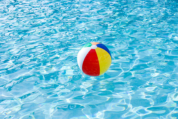 istock Beach ball floating on surface of swimming pool 120690071