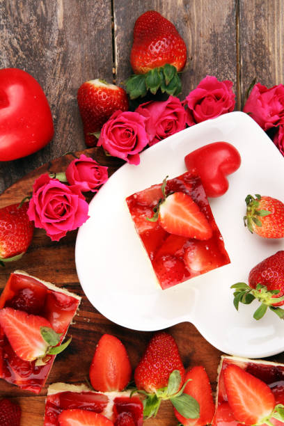 istock strawberry cake and many fresh strawberries on rustic table with hearts and roses for valentines day. 1206901103