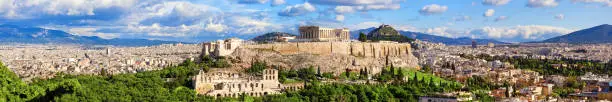 Panorama of Athens with Acropolis hill, Greece. The Acropolis of Athens located on a rocky outcrop above the city of Athens and contains the remains of several ancient buildings, the most famous being the Parthenon.