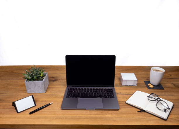 istock Table shot desk view with pencil a plant, coffee, workspace, business, laptop display and notes business card, notes book and glasses 1206901321