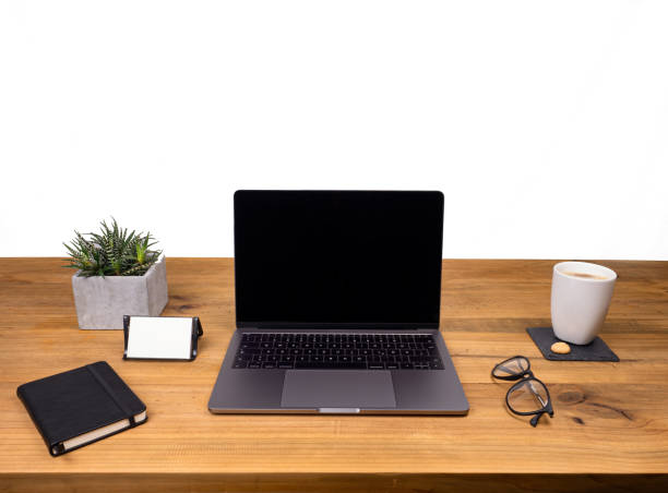 istock Table shot desk view with pencil a plant, coffee, workspace, business, laptop display and notes business card, notes book 1206901342