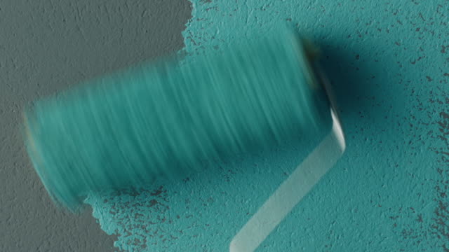 Hand painting a wall using a roller