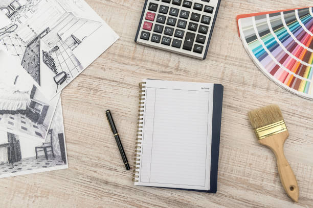 istock Unfinished  draft of classic room sketch, empty notepad, color tools on desk. 1206903586