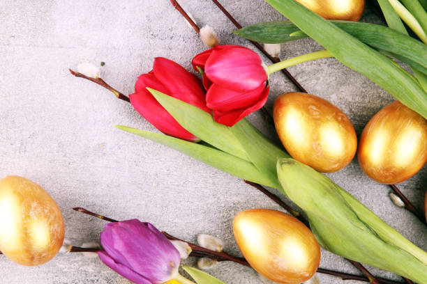 istock golden easter eggs and pussy willow cats and spring flower with tulips 1206903980