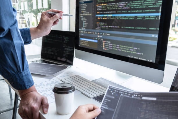 Team of developer programmer working on project in software development computer in IT company office, Writing codes and data code website and coding database technologies to find problem solution stock photo