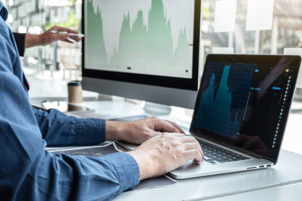 istock Business team investor working discussion in traders and pointing on the stock chart data presented new idea and deal on a stock exchange to having planning and analyzing of partner collaboration 1206904186