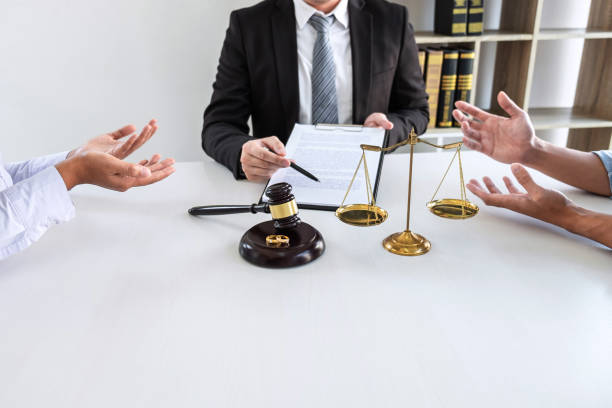 istock Young angry couple arguing telling their problems in the courthouse to getting divorced or premarital agreement in lawyers office, deciding on marriage divorce concept 1206904225