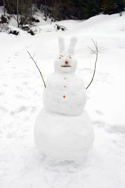 istock Snowman - three balls, big ears on his head, hands - branches 1206908644