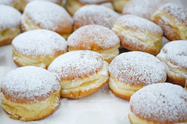 istock Homemade stuffed donuts on a parchment covered table. 1206908801