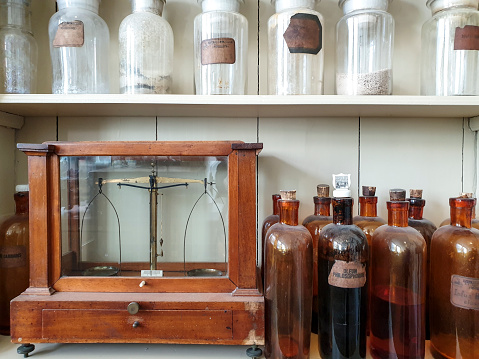 Ingredients for making medicine and old scale weight in historic pharmacy