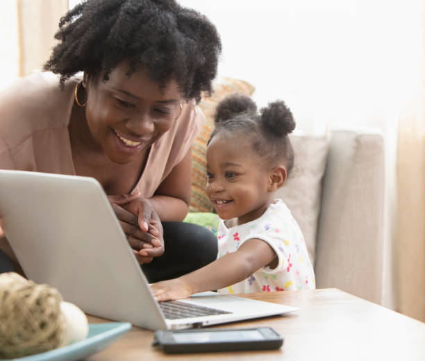 istock African American mother and her little girl using computer 1206909753