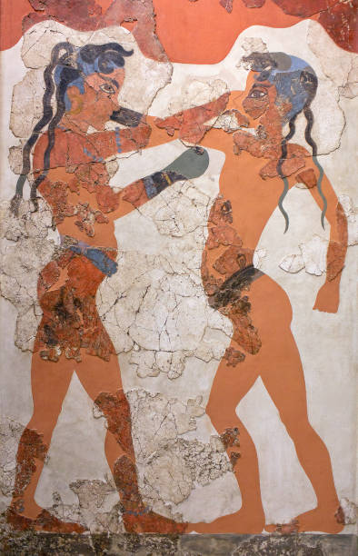 Ancient fresco from Minoan Settlement of Akrotiri on Santorini, Greece Thera, Santorini island, Cyclades, Greece - March 16, 2018: Boxing boys - wall painting fresco of Boxing Boys in Akrotiri Minoan Bronze Age settlement on the volcanic Greek island of Santorini. The Akrotiri site associated with the Minoan civilization. Akrotiri has been excavated since 1967. minoan photos stock pictures, royalty-free photos & images