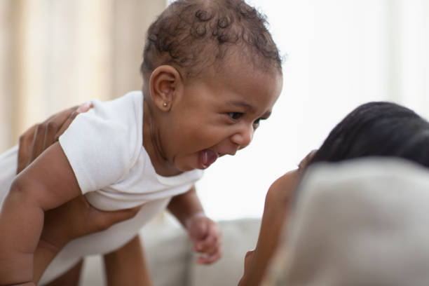 istock Smiling mom and baby on the sofa 1206909987