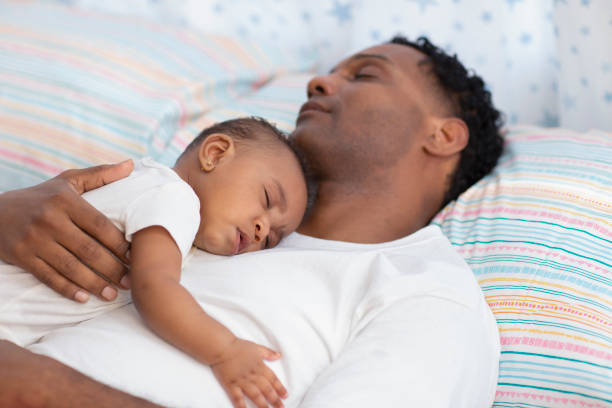 istock Young father sleeping with his baby daughter in bed 1206910043