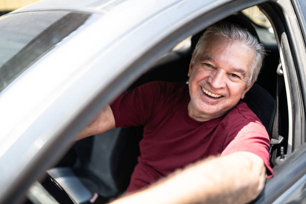 istock Portrait of senior man inside a car 1206910307