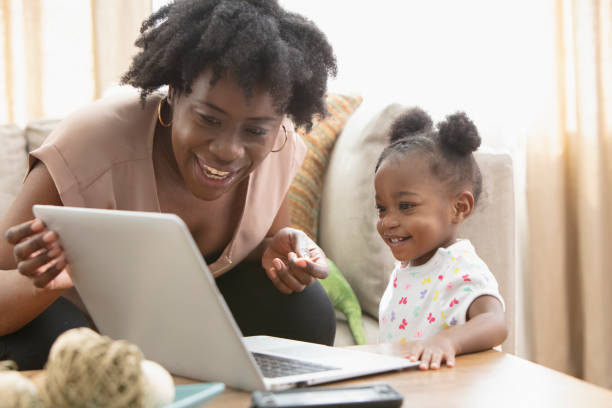 istock African American mother and her little girl using computer 1206911881