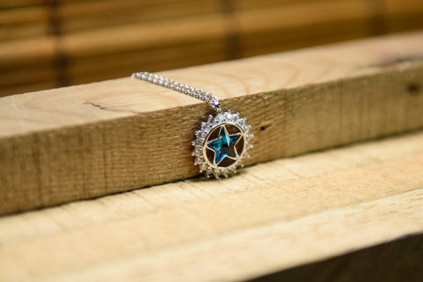 istock Silver necklace and pendant on wooden background 1206912618