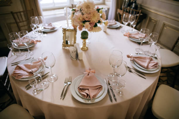istock Catering service. Table set for dinner. Dinnerware with plates on table with flowers  and candles 1206914835
