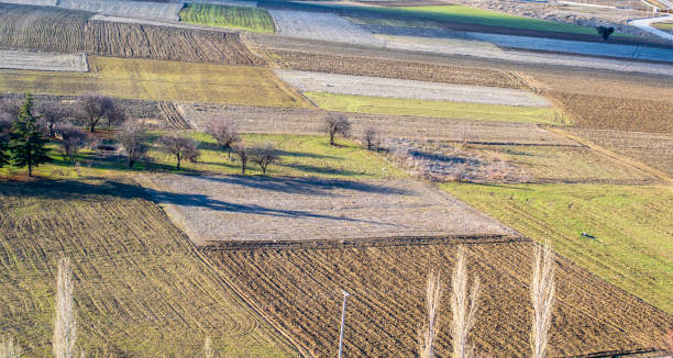 istock Aerial view of plowed fields. Soil row patterns. Preparation for planting. 1206917566