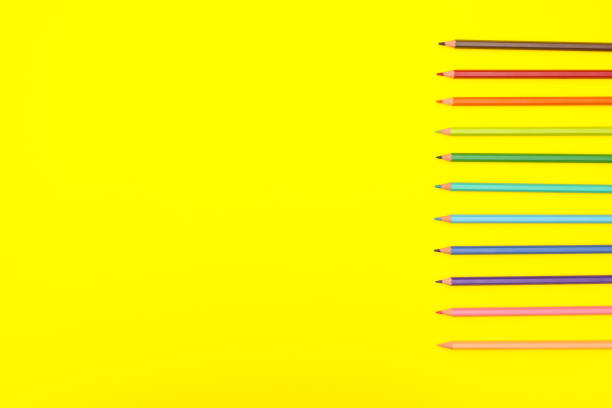 istock Colored crayons on yellow background 1206918969