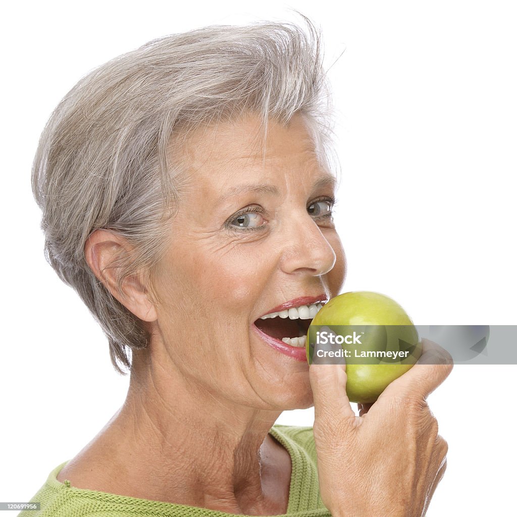 Senior woman with apple Full isolated portrait of a active senior with apple Apple - Fruit Stock Photo