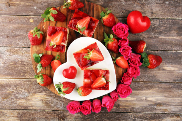 istock strawberry cake and many fresh strawberries on rustic table with hearts and roses for valentines day. 1206919955