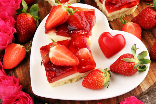 istock strawberry cake and many fresh strawberries on rustic table with hearts and roses for valentines day. 1206920514