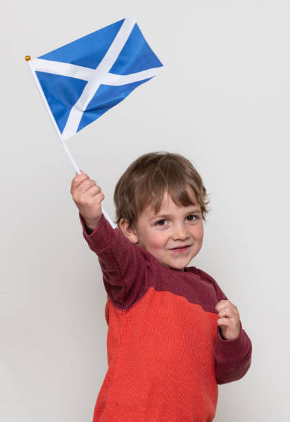 istock Smiling caucasian Child boy looking at the camera holding a Scottish flag 1206920930