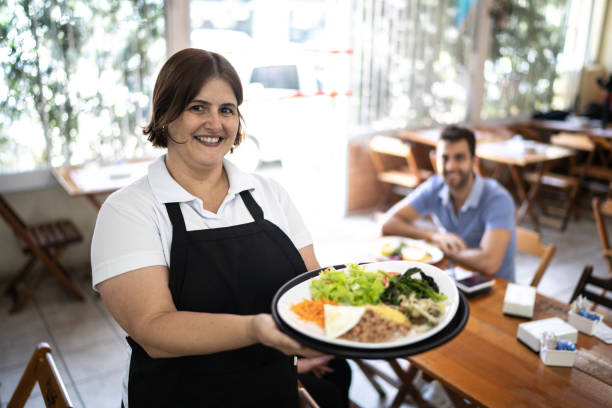 istock Portrait of a chef / waiter holding a dish 1206921106
