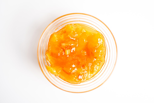 Homemade orange jelly jam in bowl top view