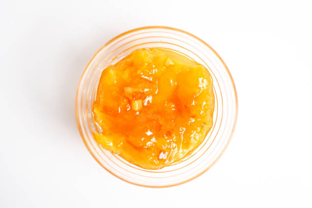 Homemade orange jelly jam in bowl Homemade orange jelly jam in bowl top view chutney stock pictures, royalty-free photos & images