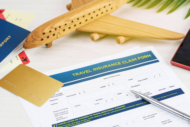 Travel insurance policy claim form with a boarding pass and passport on white wooden table. Travel insurance claim form with a boarding pass and passport on white wooden table. Travel policy concept. travel refund stock pictures, royalty-free photos & images