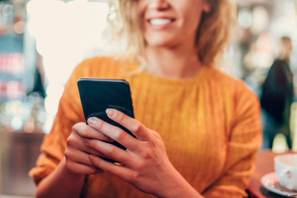 istock Woman texting on her smart phone at cafe. 1206926025
