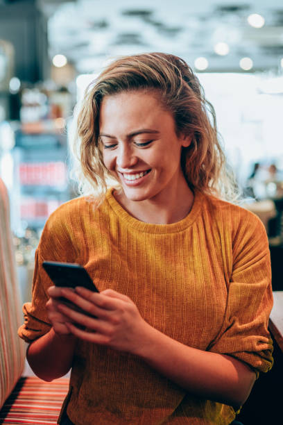 istock Woman using smartphone at a lovely cafe. 1206926099