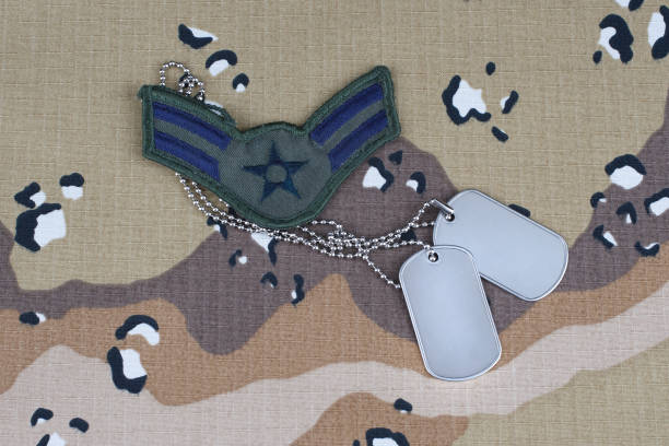 istock US AIR FORCE Airman First Class rank patch and dog tags on desert camouflage uniform background 1206926142