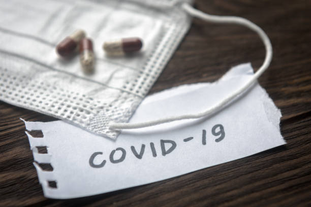 Coronavirus concept. Note COVID-19, Protective medical mask and pill capsules for treatment coronavirus. Novel corona virus outbreak.