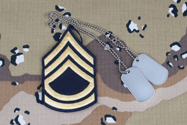 istock US ARMY Sergeant First Class rank patch and dog tags on desert camouflage uniform background 1206926249