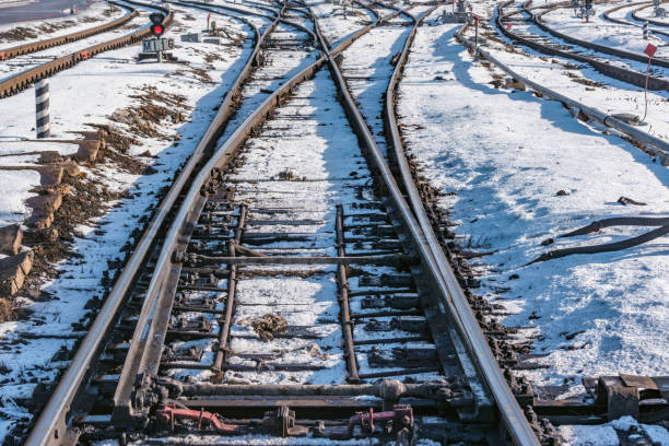 Railway tracks on the big station at winter day time.