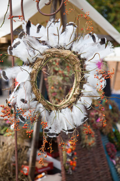 istock Autumn door wreath with feathers and berries 1206927615