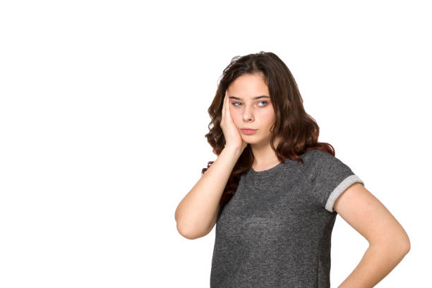 istock Young teenager with a headache on a white background 1206929453