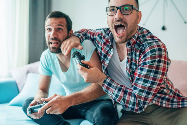 istock Excited friends playing video games 1206930389