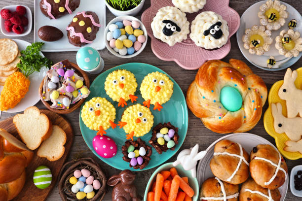 Easter table scene with an assortment of breads, desserts and treats, top view over wood Easter table scene with an assortment of breads, desserts and treats. Top view over a wood background. Spring holiday food concept. easter cake photos stock pictures, royalty-free photos & images