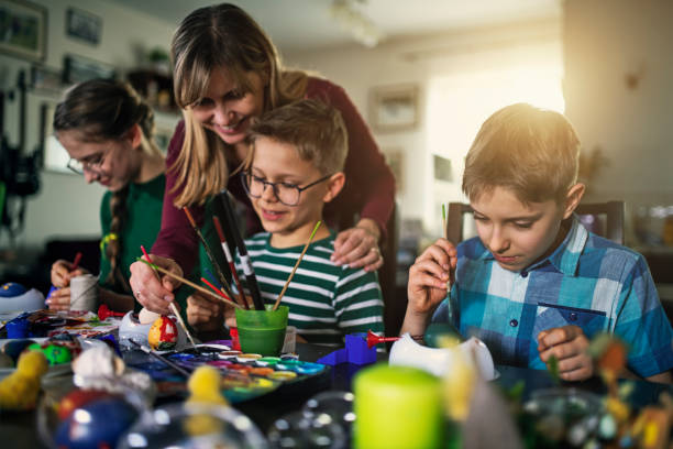 istock Family having fun painting Easter eggs 1206933322